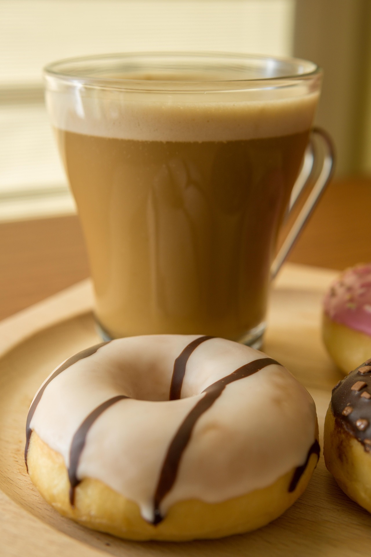 A picture of a latte and a donut.
